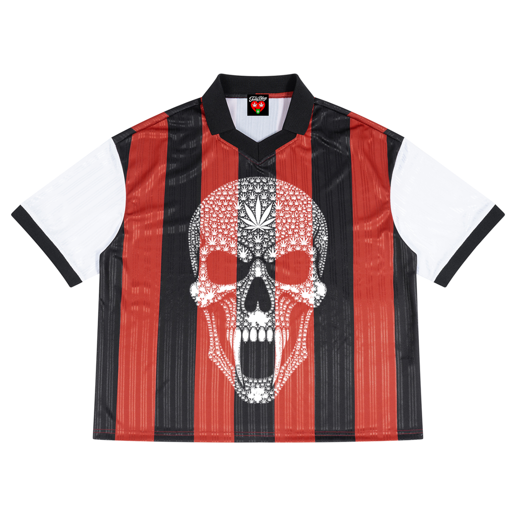 A short-sleeve soccer jersey with vertical red and black stripes, white sleeves, and a large white skull graphic on the front, shown against a plain white background.