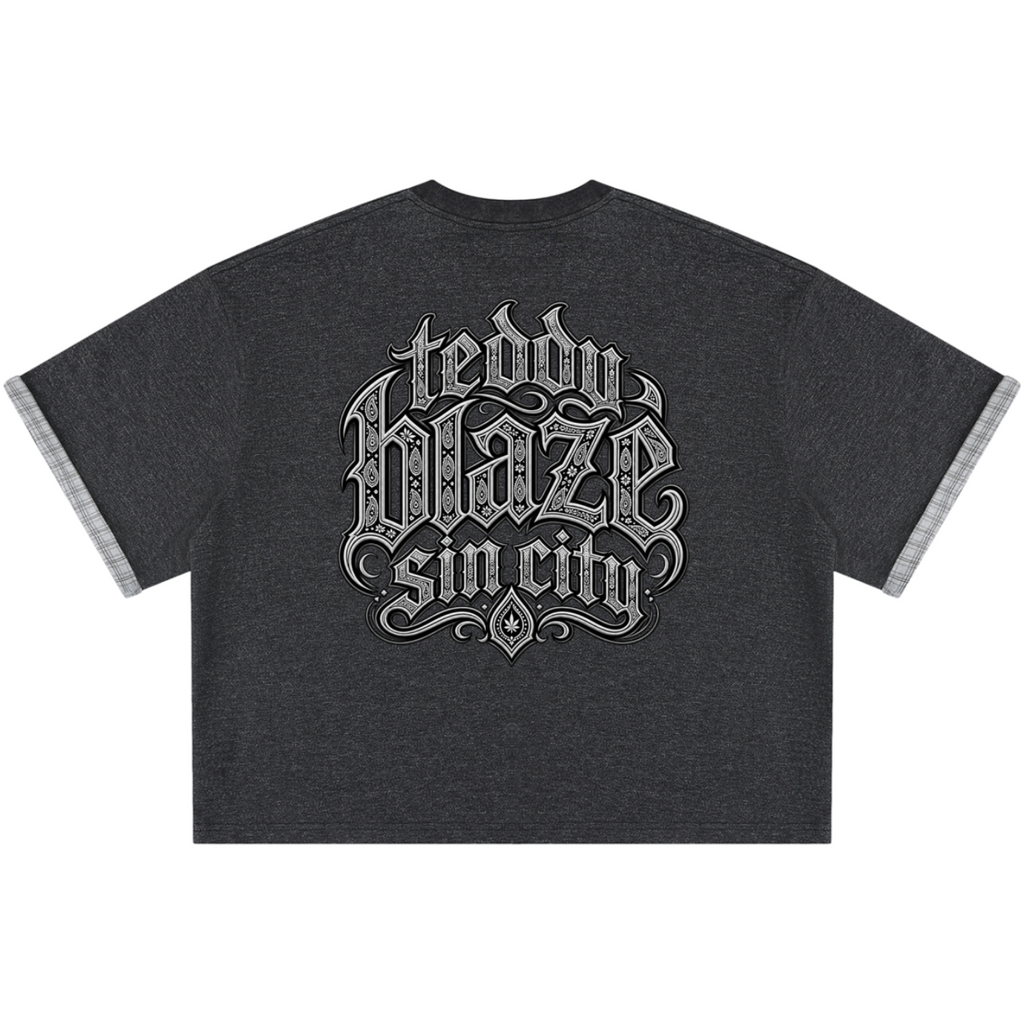 Elevate your casualwear with the Teddy Blaze Sin City Sacred Plaid-Lined Double-Face Tee. Charcoal stretch-cotton, exposed plaid trim, and tattoo praying hands print. Shop NYC to Vegas style.