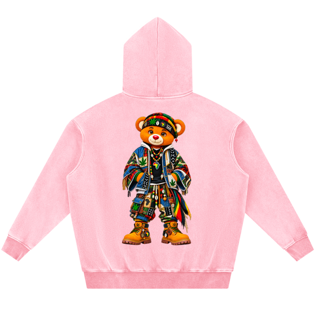 A light pink hooded sweatshirt shown from the back, featuring a large graphic of a teddy bear wearing a colorful patterned outfit and boots.