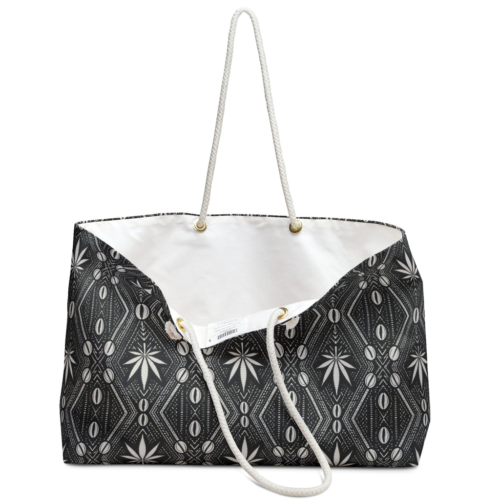 Travel with DaChek™. This oversized Teddy Blaze Weekender features bold black-and-white African-inspired patternwork, cotton rope handles, a lined interior and spacious T-bottom construction.