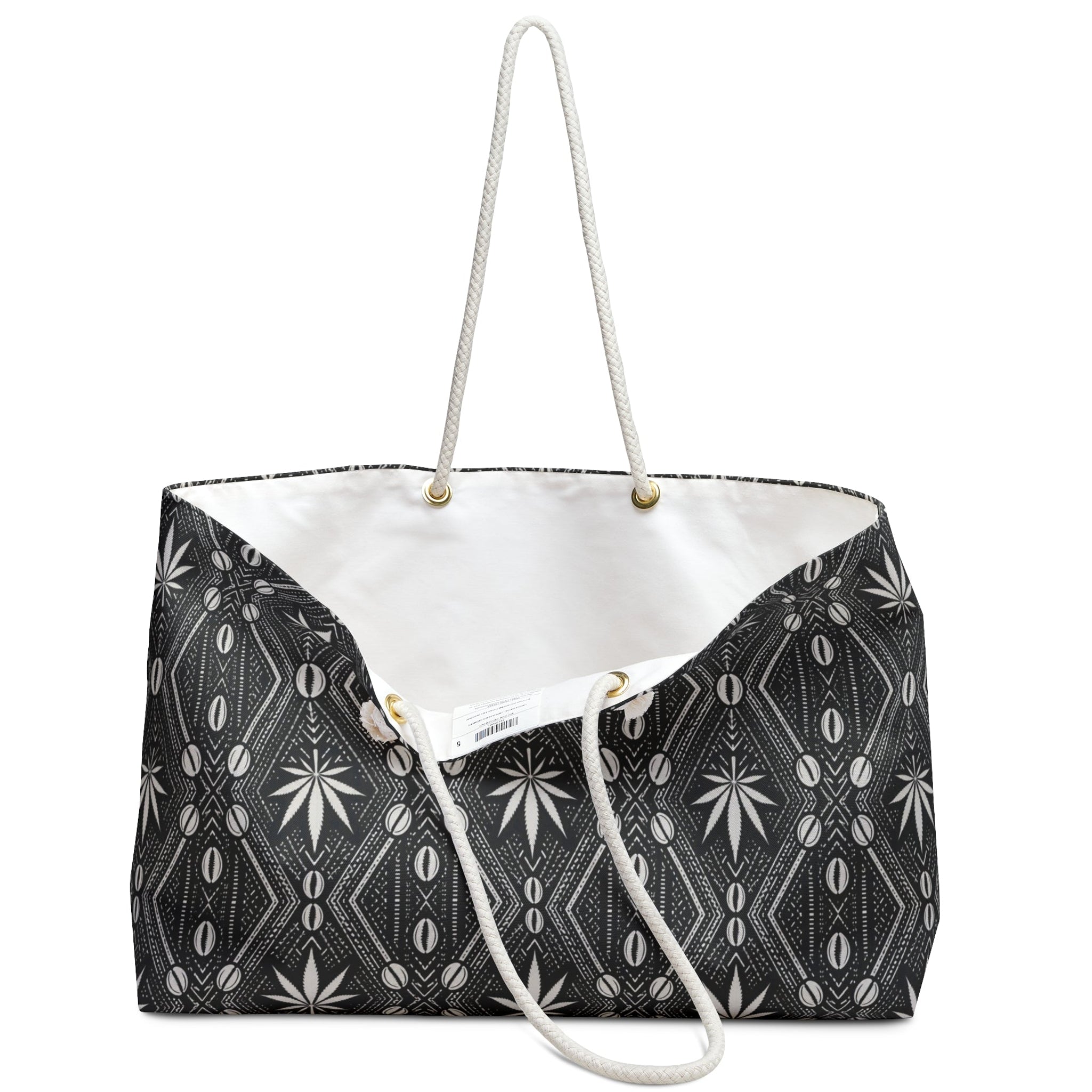 Travel with DaChek™. This oversized Teddy Blaze Weekender features bold black-and-white African-inspired patternwork, cotton rope handles, a lined interior and spacious T-bottom construction.