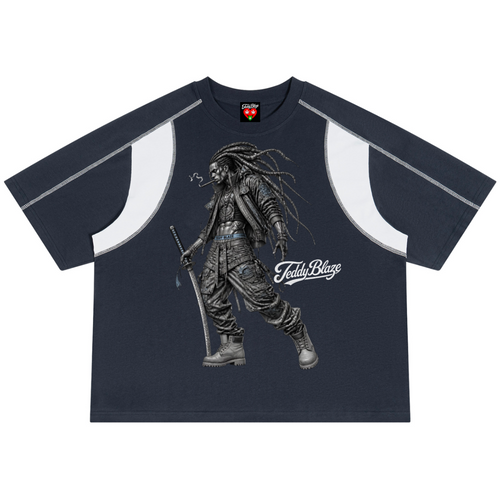 A navy blue short-sleeve t-shirt with white curved shoulder panels and a large graphic of a dreadsled warrior holding a sword on the front. The graphic includes the text 'FettyBlaze'.