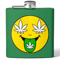 A green metal hip flask with a silver screw cap and side spout, featuring a large yellow smiley face graphic on the front with white cannabis leaves for eyes and a green leaf on the tongue.