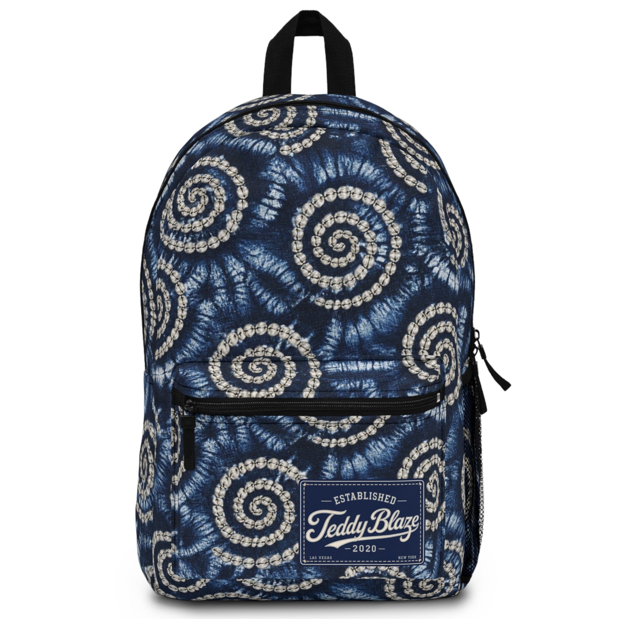 A navy blue backpack with a white spiral tie-dye pattern, featuring a front zippered pocket and a 'Teddy Blaze' brand patch on the front.