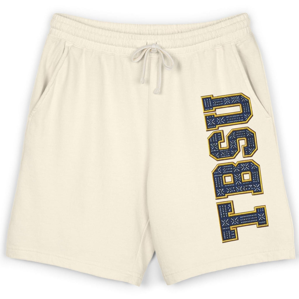 Cream-colored athletic shorts featuring a vertical 'USU 1851' graphic in navy blue and gold on the left leg, with a matching cream drawstring waistband.