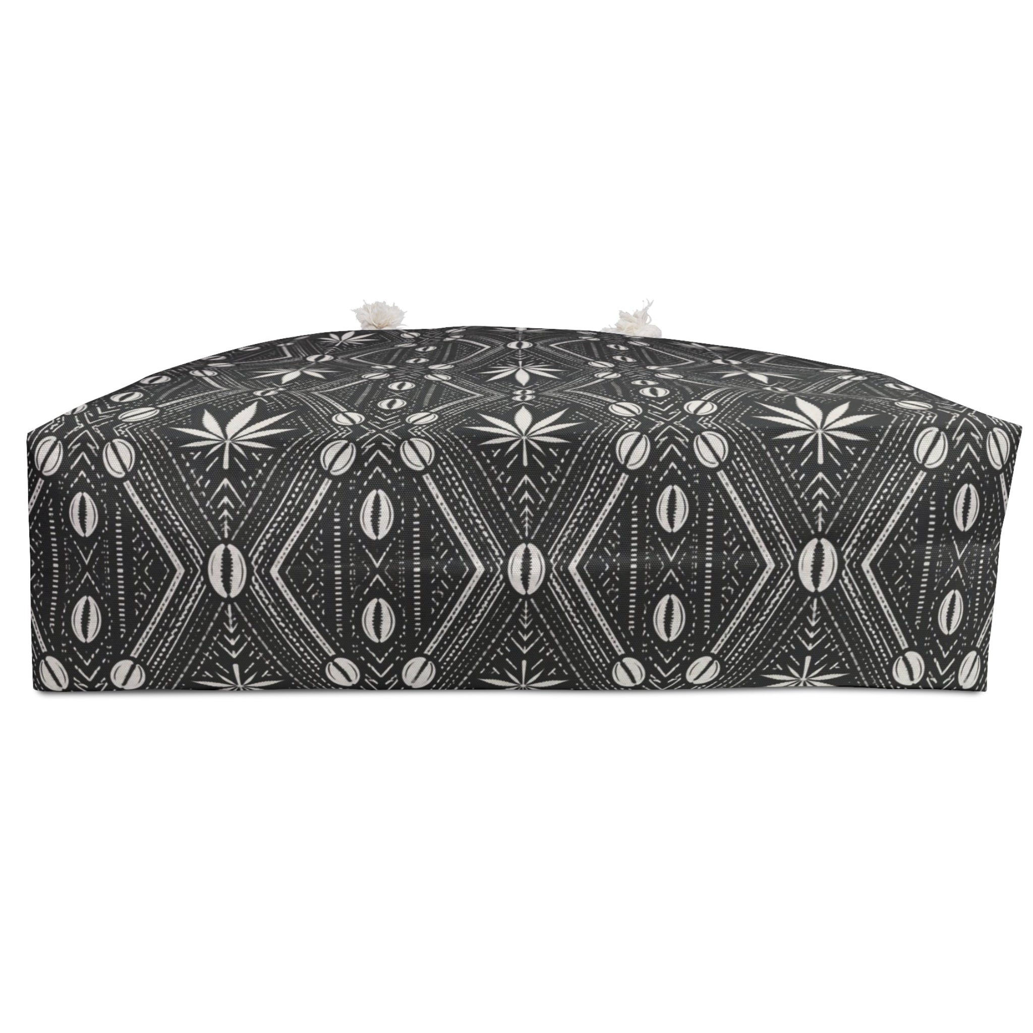 Travel with DaChek™. This oversized Teddy Blaze Weekender features bold black-and-white African-inspired patternwork, cotton rope handles, a lined interior and spacious T-bottom construction.