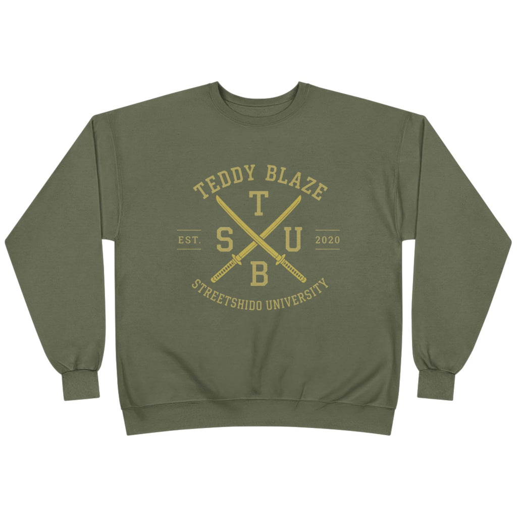 An olive green crewneck sweatshirt with a gold graphic on the chest reading 'TEDDY BLAZE' and 'STREETSHOO UNIVERSITY' around crossed 'TSUB' letters, shown on a plain white background.