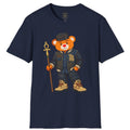 A navy blue short-sleeve t-shirt featuring a cartoon graphic of a teddy bear dressed in a denim jacket, jeans, and boots, holding a staff, displayed on a solid white background.