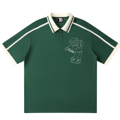 Green polo shirt with white trim and bear graphic on a white background
