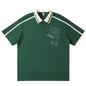Green polo shirt with white trim and bear graphic on a white background