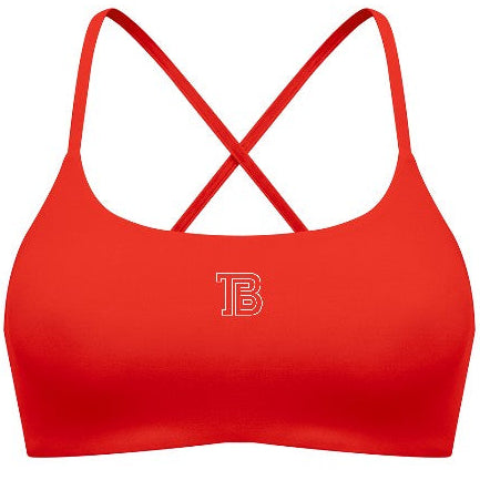 Red sports bra with criss-cross straps on a white background