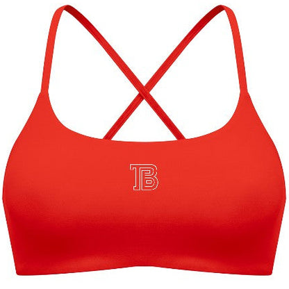 Red sports bra with criss-cross straps on a white background