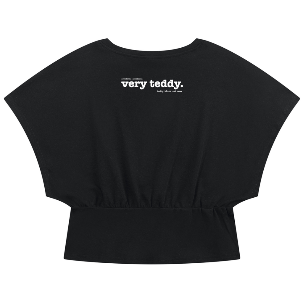 Discover the Teddy Blaze Afrodemia Americana Crop Dolman Tee, cut in a cotton-stretch blend with a gathered waist and signature Afrodemia iconography.