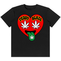 A black short-sleeve crewneck t-shirt featuring a graphic of a red heart with the words 'TEDDY BLAZE' in yellow, two white cannabis leaves as eyes, and a green tongue sticking out with a white cannabis leaf on it, shown against a plain white background.
