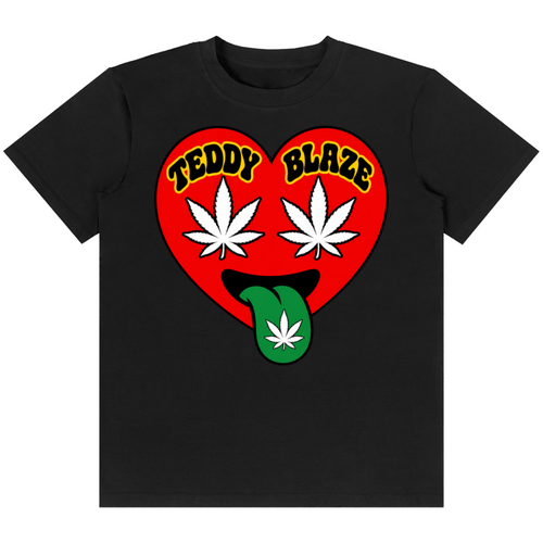 A black short-sleeve crewneck t-shirt featuring a graphic of a red heart with the words 'TEDDY BLAZE' in yellow, two white cannabis leaves as eyes, and a green tongue sticking out with a white cannabis leaf on it, shown against a plain white background.