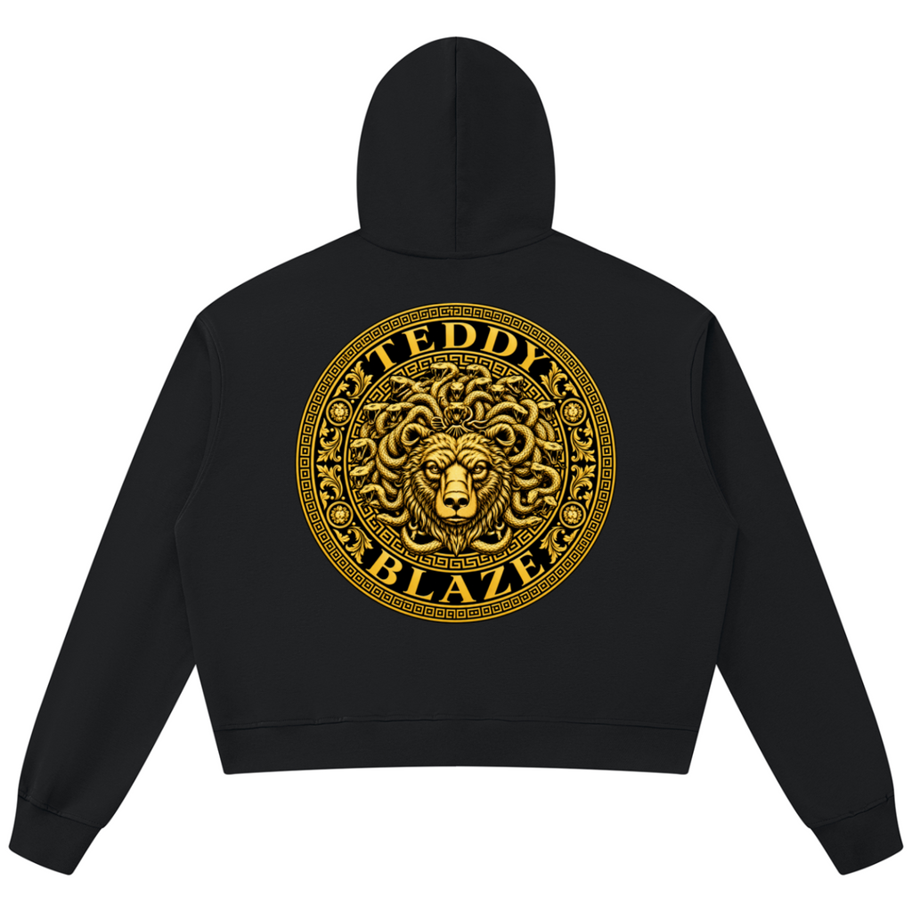 Elevate your statement outerwear with the House of Teddy Blaze Beardusa V-Neck Box Cut Raw Edge Fleece Hoodie. Black 360 gsm fleece, notched V-neck collar, raw edge details, and gold Medusa bear graphics. Shop NYC to Vegas style.