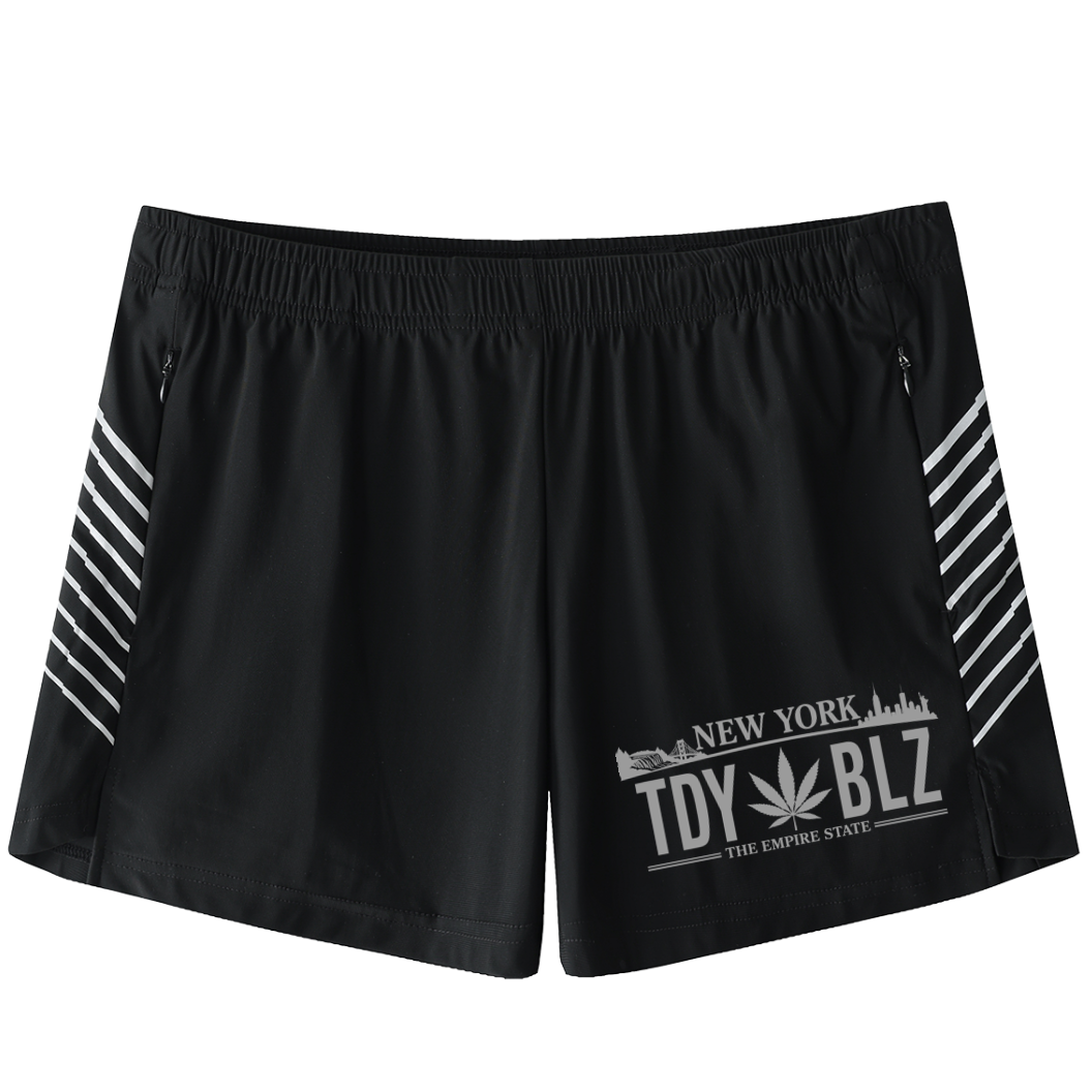 Black athletic shorts with white graphic prints on the left leg and white diagonal stripes on the sides, shown against a plain white background.