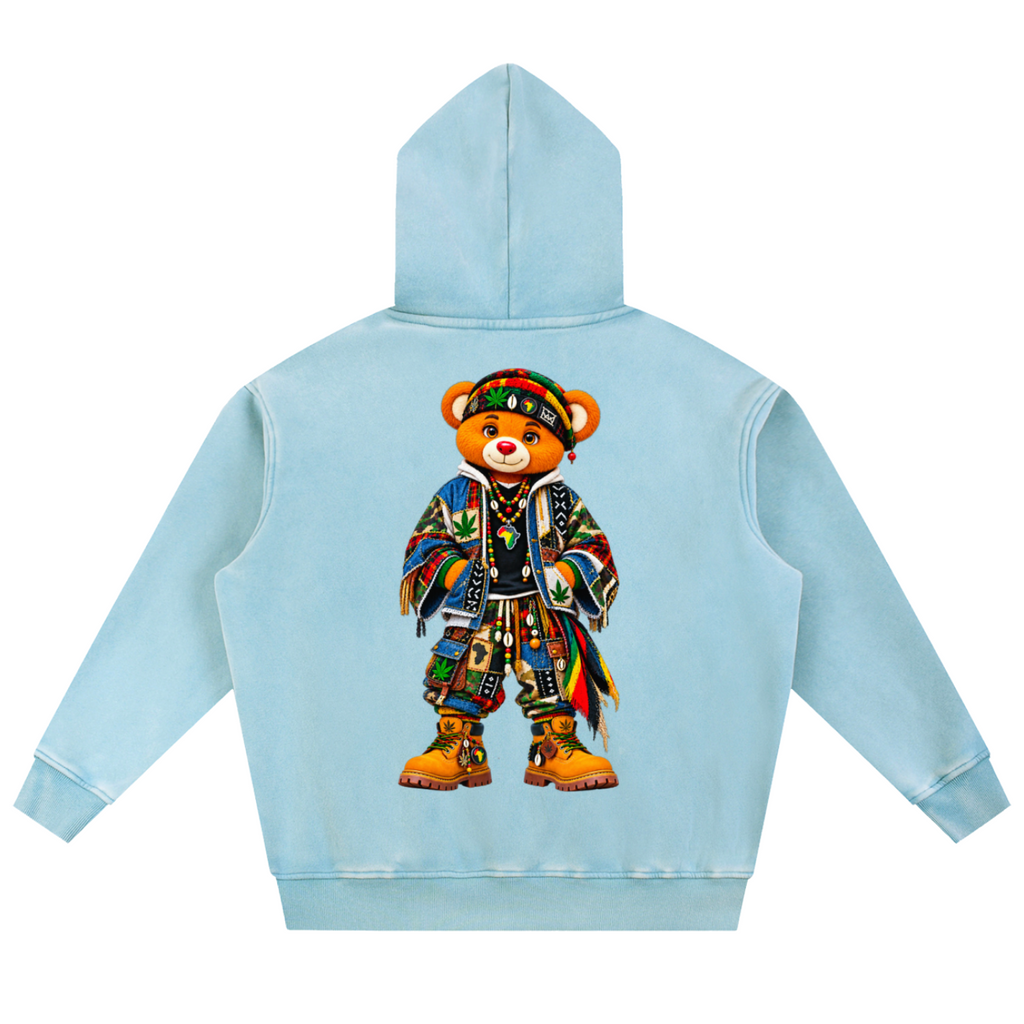 A light blue hooded sweatshirt shown from the back, featuring a large graphic of a teddy bear dressed in colorful, patterned clothing and boots.