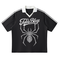 A black short-sleeve soccer jersey with white double stripes on the sleeves, a white V-neck collar, and a large white spider graphic with the text 'TeddyBlaze' across the chest, shown on a plain white background.