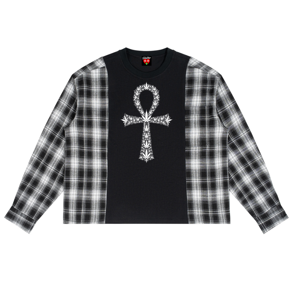 A long-sleeve crop top featuring a black center panel with a white ornate cross graphic, and black-and-white plaid sleeves, shown flat on a white background.