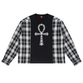 A long-sleeve crop top featuring a black center panel with a white ornate cross graphic, and black-and-white plaid sleeves, shown flat on a white background.