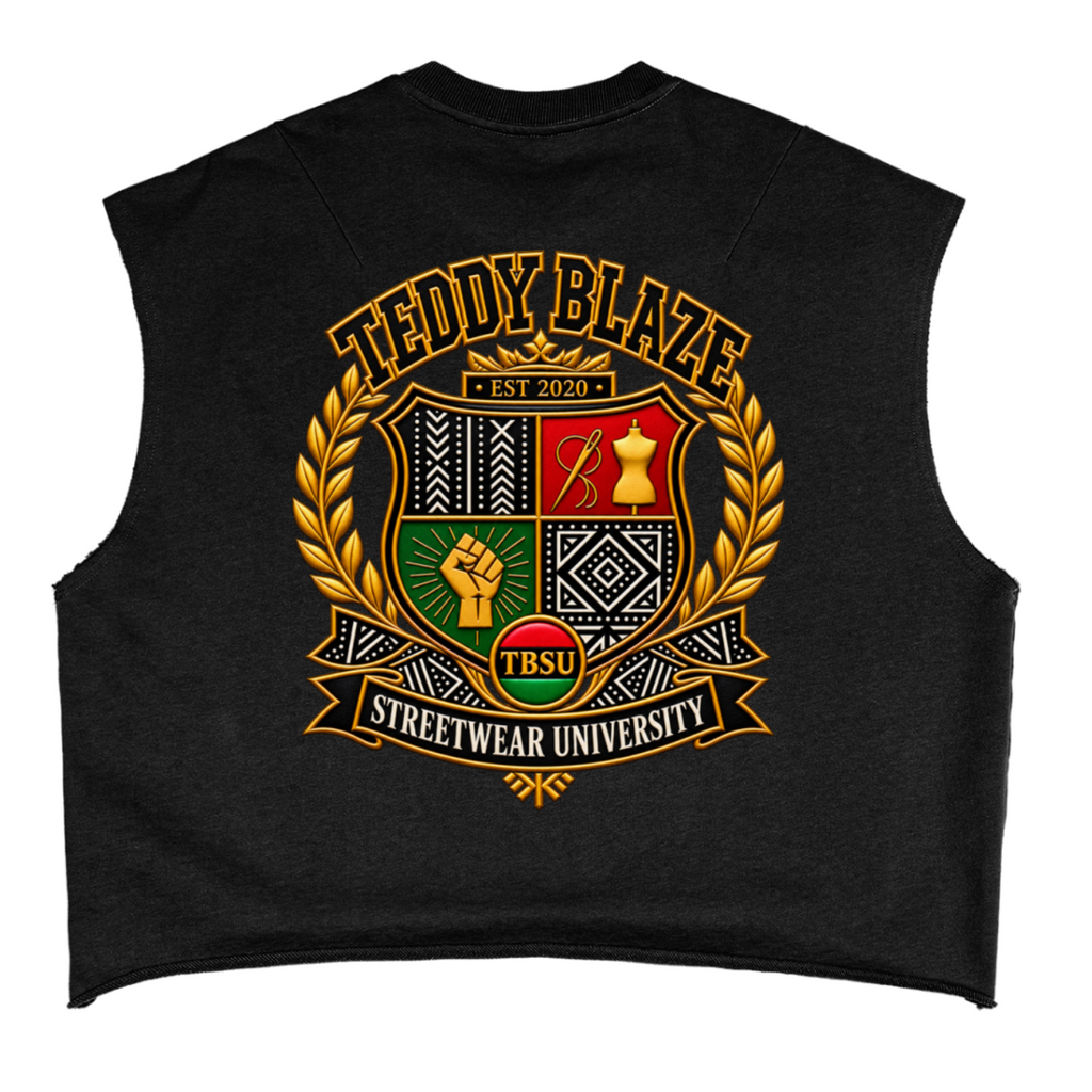 A black sleeveless crop top featuring a large, detailed graphic on the front. The graphic displays a gold laurel wreath framing a four-quadrant crest with red, green, black, and gold details, topped with the text 'TEDDY BLAZE EST 2020' and a banner reading 'STREETWEAR UNIVERSITY'.