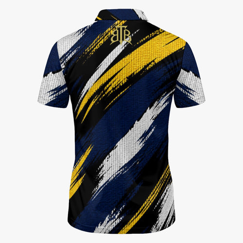 Short-sleeve polo shirt shown from the back, featuring a bold abstract brushstroke pattern in navy blue, black, yellow, and white, with a gold monogram logo at the collar.