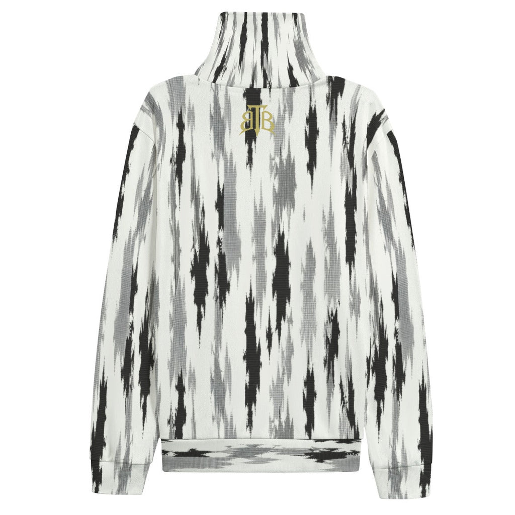 A long-sleeve mock neck sweatshirt featuring a vertical black, gray, and white ikat pattern, with a small gold embroidered 'JB' logo on the upper back.