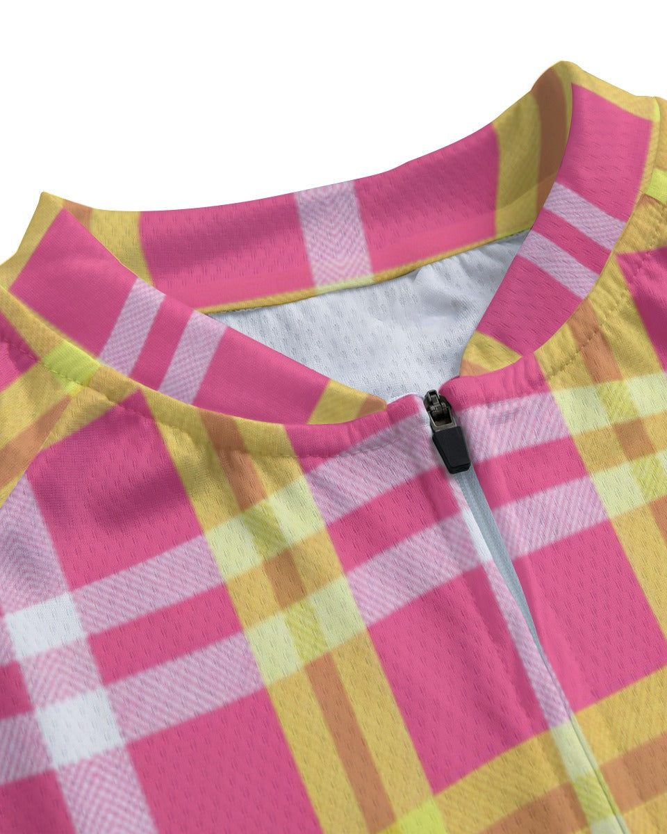 Close-up of a cycling jersey with a pink, yellow, and white plaid pattern, featuring a mock neck collar and a black zipper.