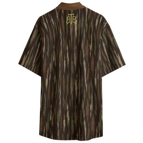 A short-sleeve collared shirt with a vertical ikat-style pattern in brown, olive green, and beige, featuring a gold monogram logo on the back neck, shown against a plain white background.