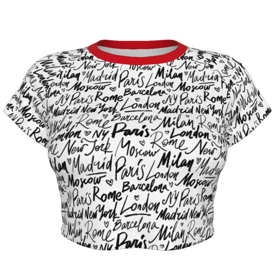 Shop the Jet Setter Cropped Tee by Teddy Blaze. Soft 180g/m² microfiber raglan crop featuring a contrast red neck trim and all-over global city script pattern.