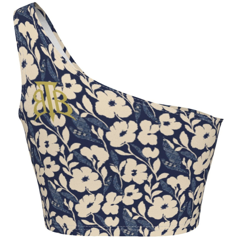 Shop the Adire Florale One-Shoulder Cropped Top by Teddy Blaze. High-support 230g/m² stretch crop featuring an asymmetrical neck and botanical Adire print.