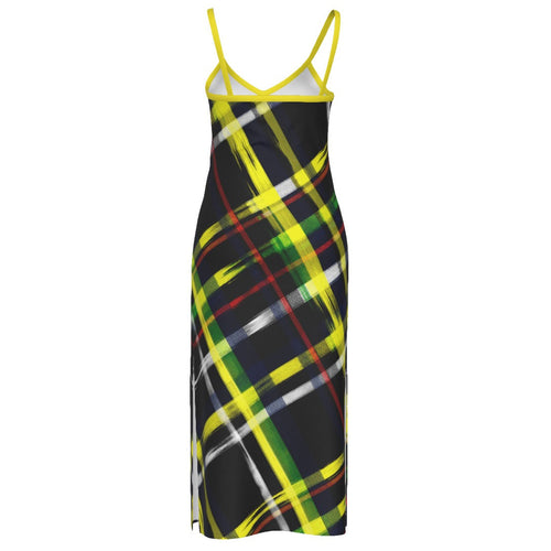 A sleeveless slip dress with thin straps, featuring a black background with a vibrant yellow, green, red, and white plaid pattern, shown against a plain white background.