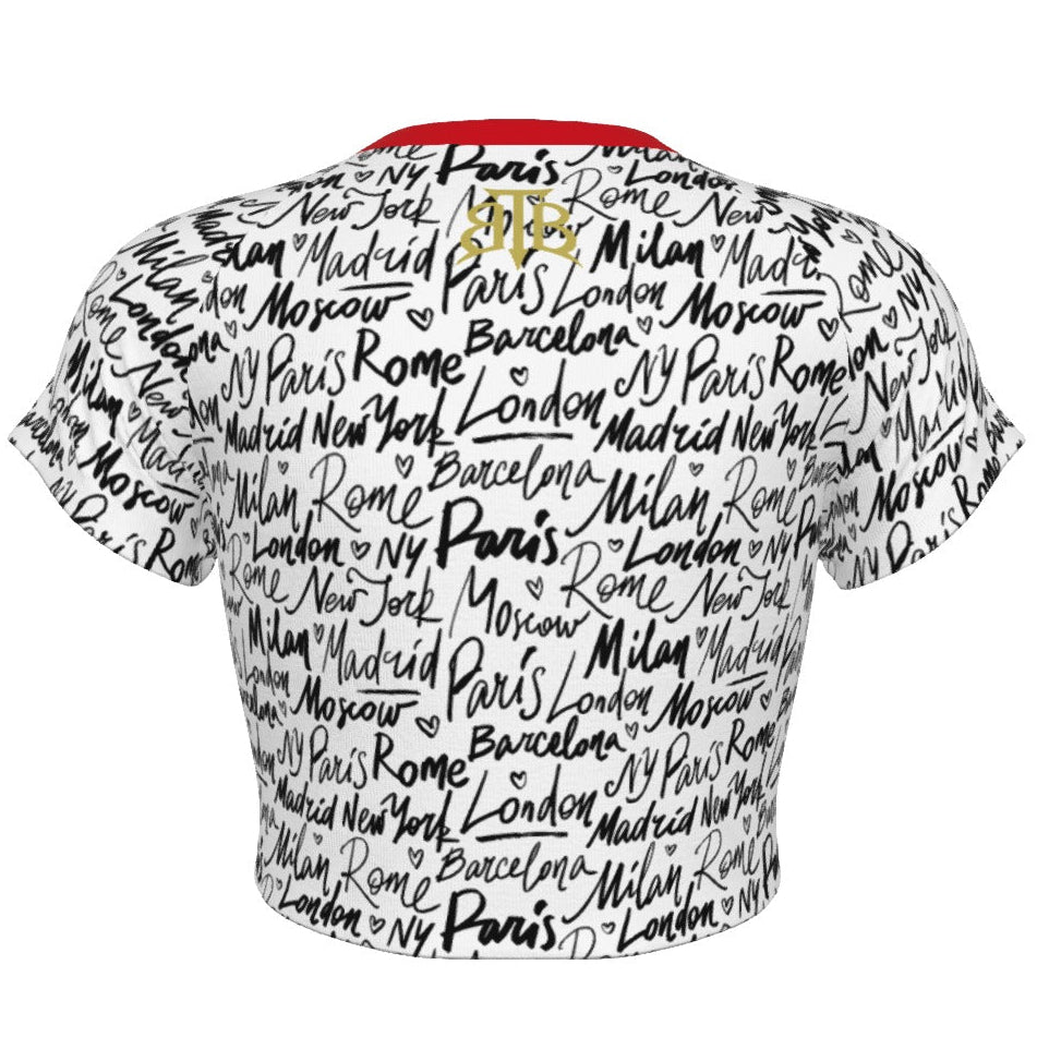 Shop the Jet Setter Cropped Tee by Teddy Blaze. Soft 180g/m² microfiber raglan crop featuring a contrast red neck trim and all-over global city script pattern.