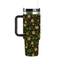 A travel tumbler with a black handle, black lid, and a clear straw, featuring a dark green and black background patterned with tan and olive green cannabis leaves.