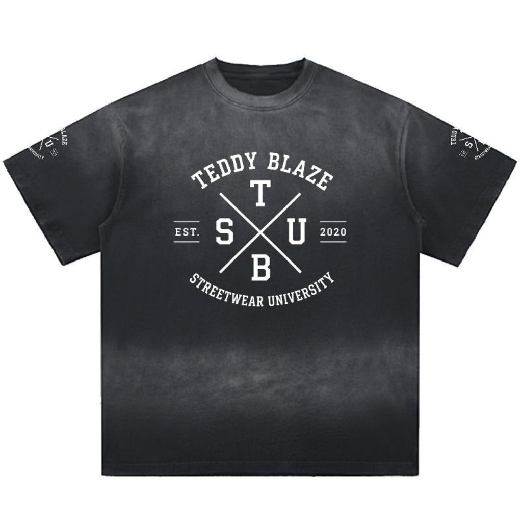 A black short-sleeve t-shirt with a white graphic print on the front reading 'TEDDY BLAZE STREETHWEAR UNIVERSITY' with 'T S U' in the center and 'EST. 2020' on either side of crossed lines.