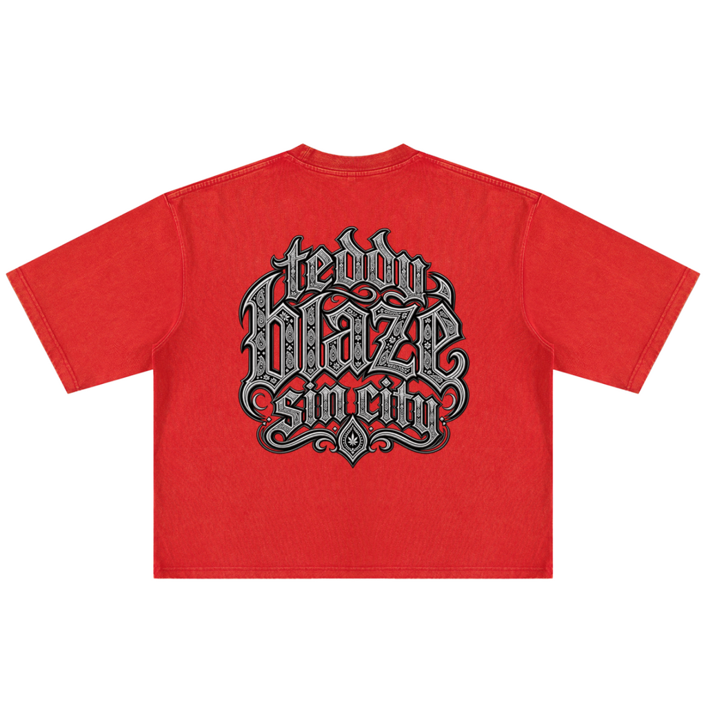 Elevate your streetwear with the Teddy Blaze Sin City Sacred Snow Wash Boxy Cotton Tee. Red snow-washed heavy cotton, tattoo praying hands print, and boxy cut. Shop NYC to Vegas style.