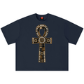 A navy blue short-sleeve t-shirt with a large Egyptian ankh symbol graphic on the chest, featuring gold, beige, and white patterned details, displayed flat against a white background.