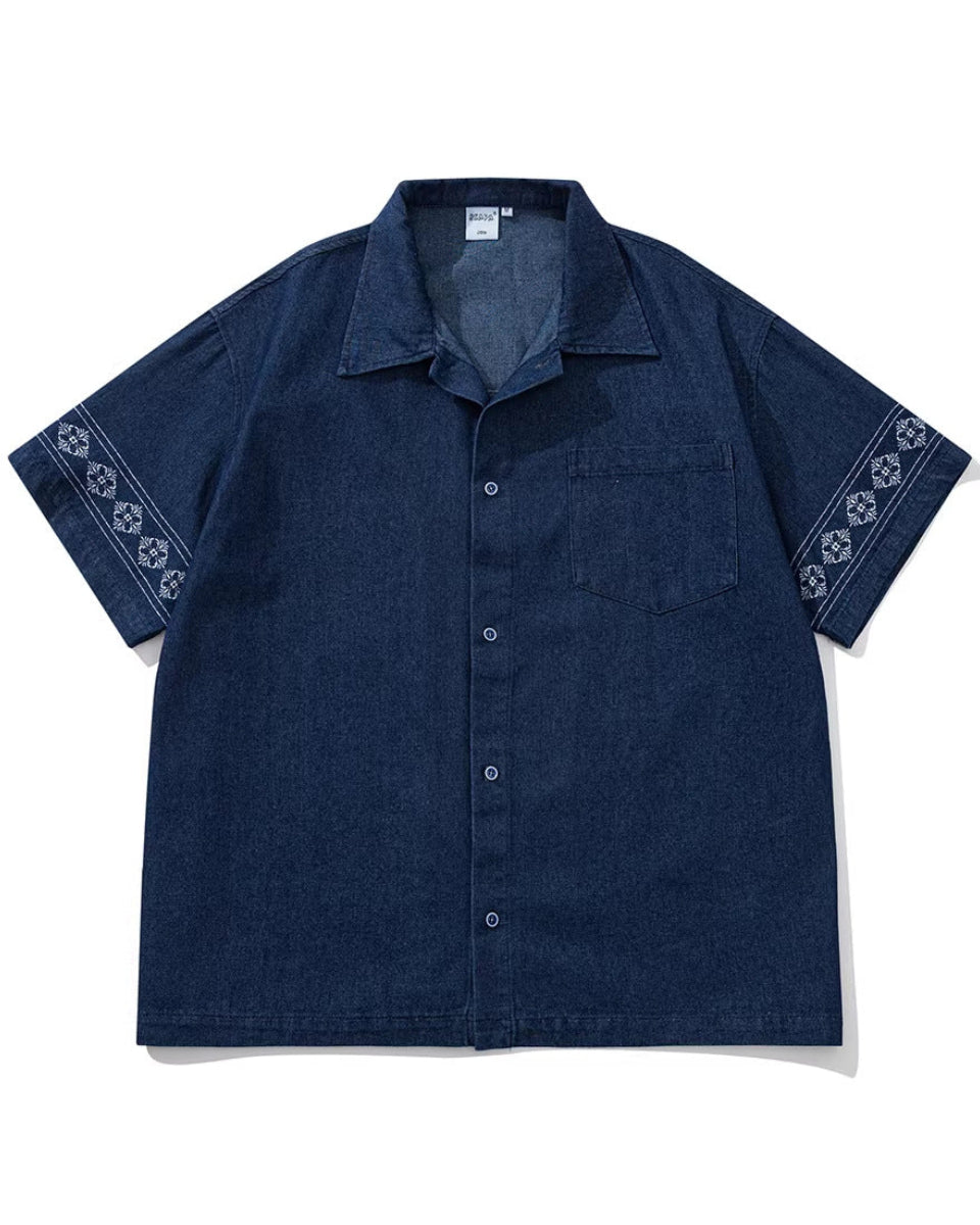 Shop the Iron + Ivy Border-Printed Denim Cuban Collar Shirt by Teddy Blaze. Men’s loose-fit indigo denim short-sleeve shirt featuring floral border sleeve prints