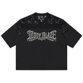 A black short-sleeve t-shirt with a sheer black lace yoke across the shoulders and upper chest, featuring a stylized silver 'TEDDY BLAZE' graphic printed across the chest, shown flat on a white background.
