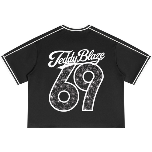 A black short-sleeve crop top t-shirt with white sleeve stripes and a large white graphic on the back reading 'Teddy Blaze 69' filled with a floral pattern.