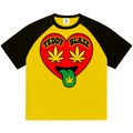 A raglan-style t-shirt with a bright yellow body and black sleeves, featuring a large red heart graphic on the chest with the words 'TEDDY BLAZE' and two yellow cannabis leaves as eyes, with a green tongue sticking out.