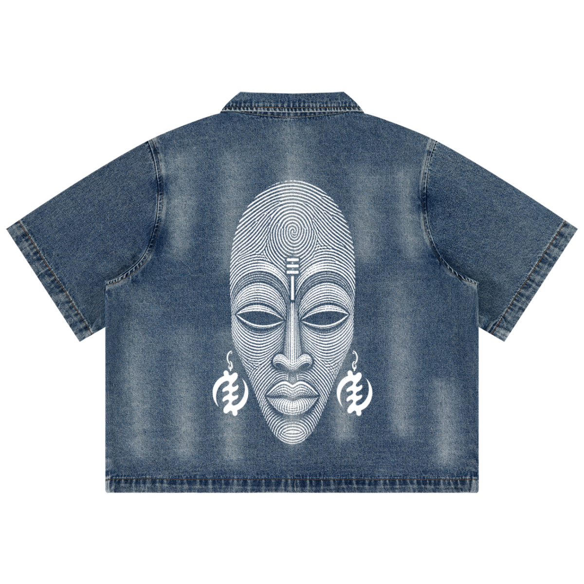 A blue denim short-sleeve shirt shown from the back, featuring a large white graphic print of an African-style face with circular line details and earrings.