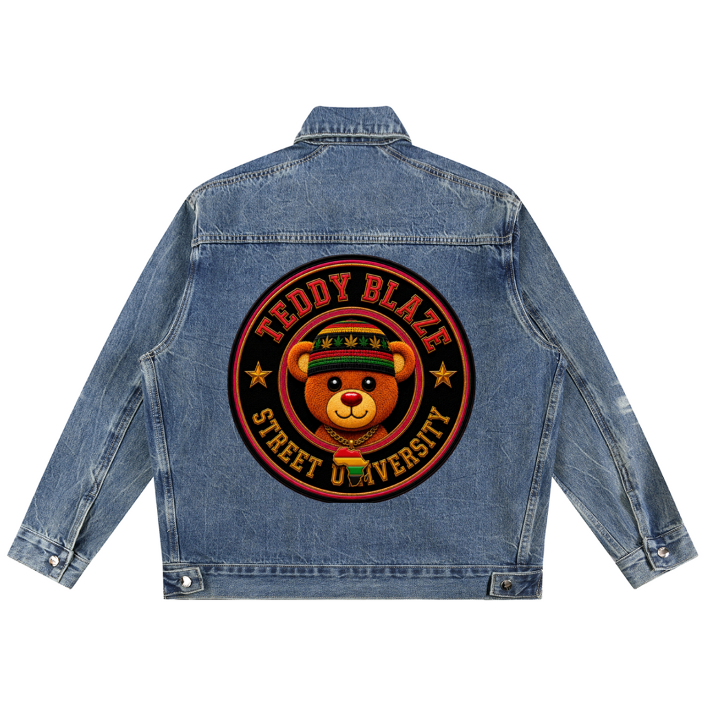 A blue denim jacket shown from the back, featuring a large circular graphic print with a cartoon teddy bear wearing a cap and the text 'TEDDY BLAZE STREET UNIVERSITY'.