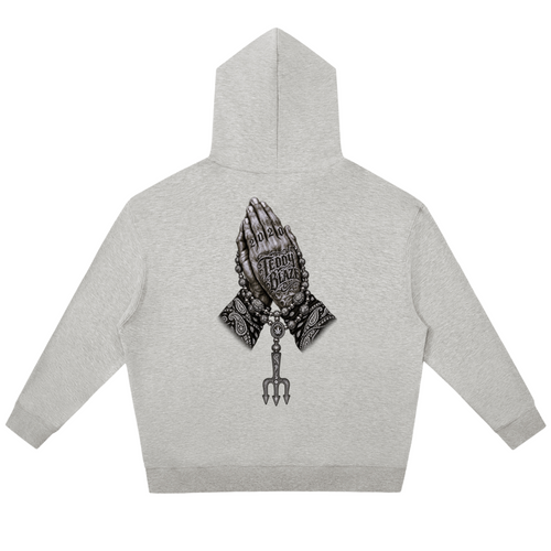 Elevate your cool-weather layers with the Teddy Blaze Sin City Relaxed Pullover Hoodie. Heather gray fleece hoodie with Sin City front print and tattoo praying hands back graphic. Shop NYC to Vegas style.