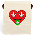 An off-white canvas tote bag with brown shoulder straps, featuring a graphic of a red heart with white cannabis leaves for eyes and a green tongue sticking out with a cannabis leaf.