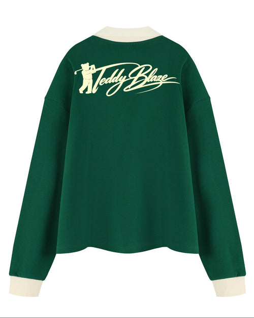 Shop the Iron + Ivy Signature Santa Blaze Contrast Trim Long Polo by Teddy Blaze. Heavyweight 320 GSM forest green cotton-poly long-sleeve polo with cream contrast collar and festive Santa bear graphic.