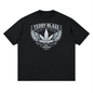 A black short-sleeve crewneck t-shirt with a white graphic print on the chest featuring a winged cannabis leaf, the text 'TEDDY-BLAZE', and 'EST. 2020'.