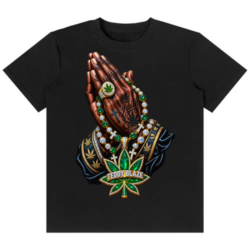 A black short-sleeve crewneck t-shirt featuring a detailed graphic print of a praying hand adorned with a green cannabis leaf medallion, gold rings, and a large green and gold 'TEDDY BLAZE' marijuana leaf pendant.