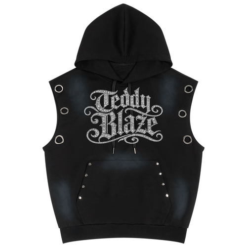 A black sleeveless hooded vest with a front kangaroo pocket, featuring a large silver glittery 'Teddy Blaze' logo on the chest, side eyelets, and silver studs, shown against a plain white background.